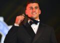 Nick Daicos holds the 2026 Brownlow Medal after his record-breaking win.