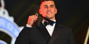 Nick Daicos holds the 2026 Brownlow Medal after his record-breaking win.