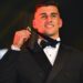Nick Daicos holds the 2026 Brownlow Medal after his record-breaking win.