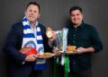 David King and Leigh Montagna pose with breakfast dishes and the premiership cup ahead of the 2026 North Melbourne Grand Final Breakfast.