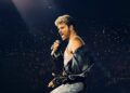 George Michael performing during The Faith Tour concert film.