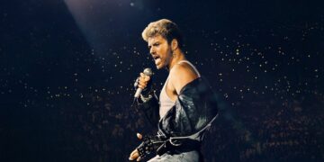 George Michael performing during The Faith Tour concert film.