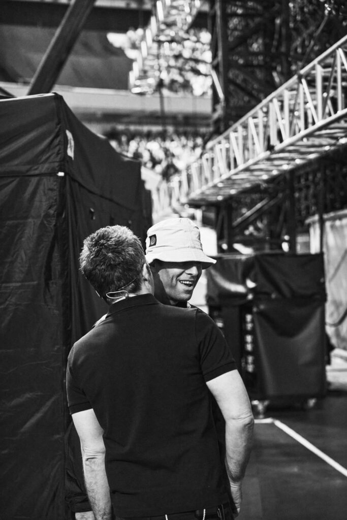 Liam and Noel Gallagher embracing backstage during the Oasis reunion tour