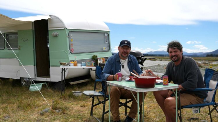 Colin Fassnidge and Manu Feildel beside their caravan in Aotearoa
