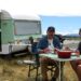 Colin Fassnidge and Manu Feildel beside their caravan in Aotearoa