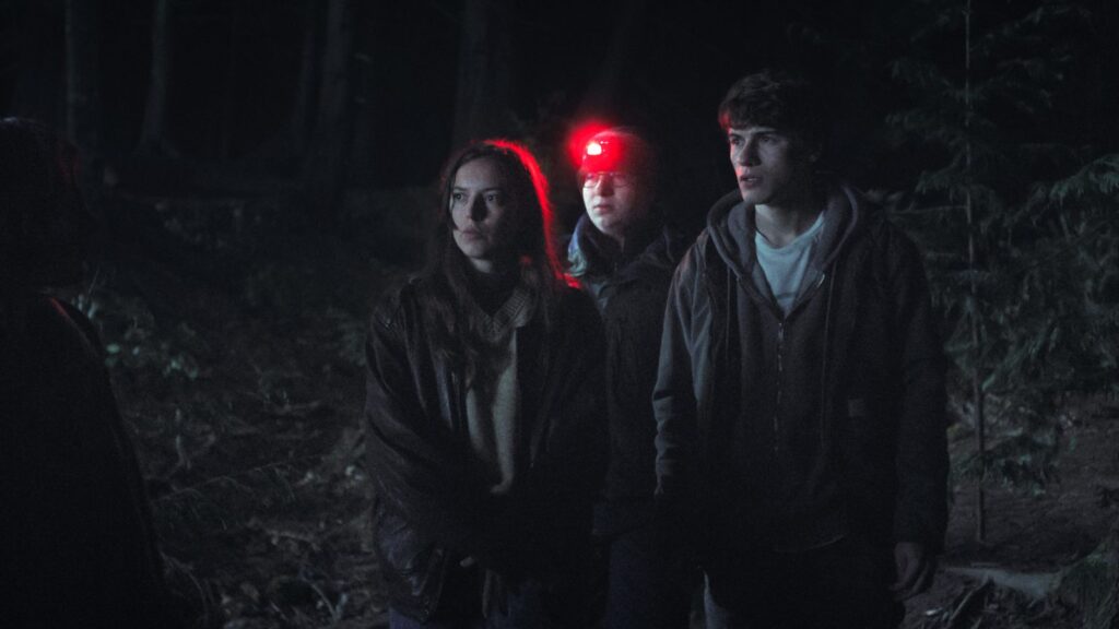 The cast of Phony in a production still from the Disney+ series