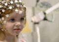 A young child undergoing an EEG assessment in the documentary Raising Superheroes