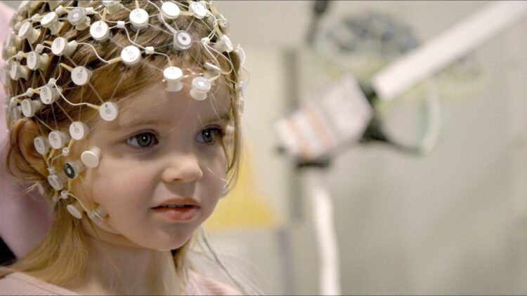 A young child undergoing an EEG assessment in the documentary Raising Superheroes