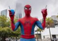 Spider-Man holding two spider drinks in Sydney for the Brand New Day fan pop-up