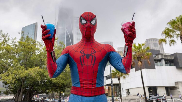 Spider-Man holding two spider drinks in Sydney for the Brand New Day fan pop-up