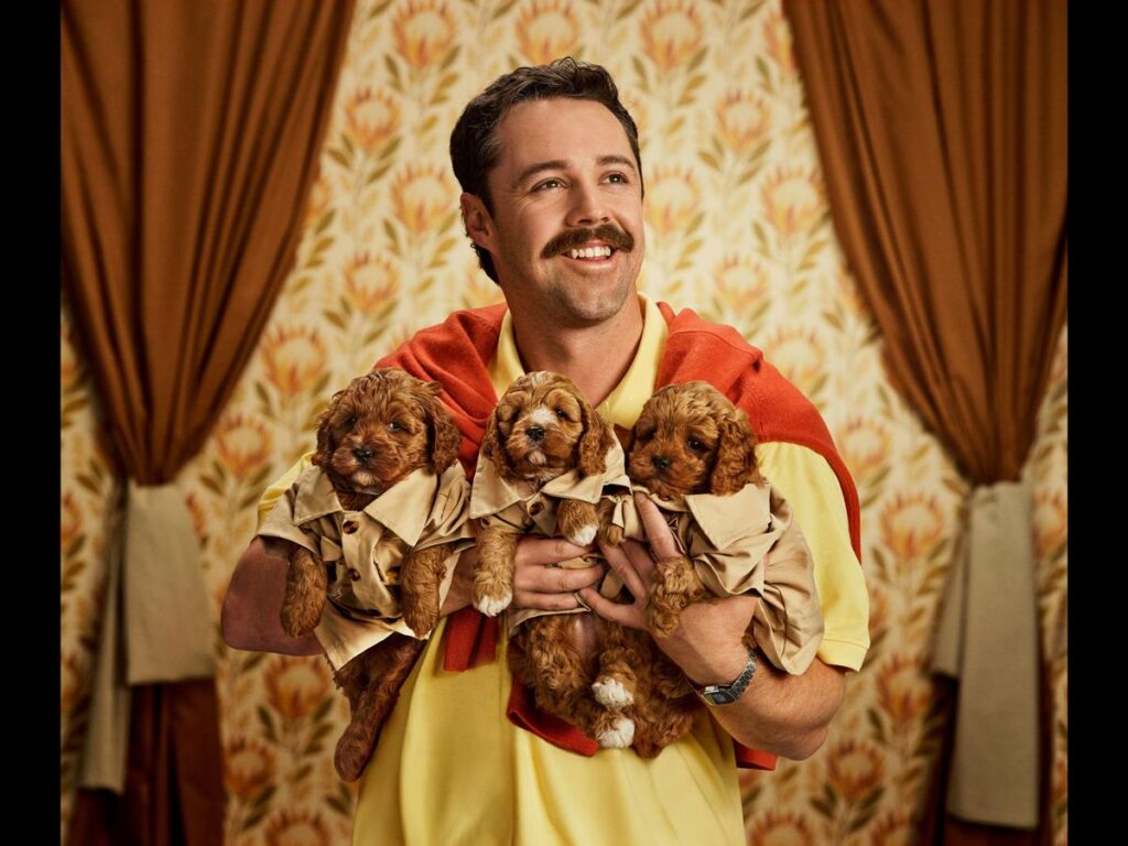 Travis Head with puppies for Kayo Sports' cricket calendar