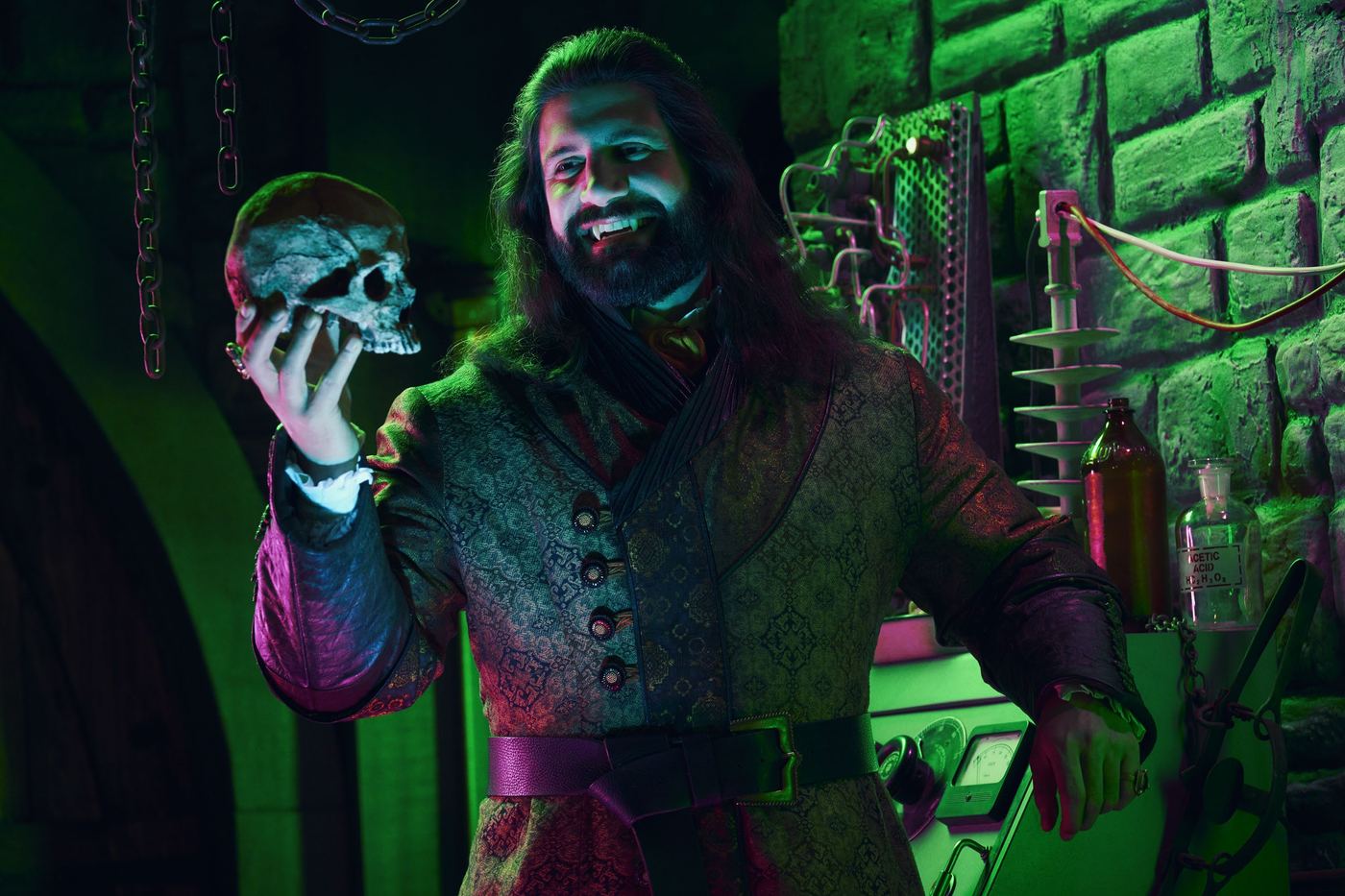 A vampire holds a skull in What We Do in the Shadows.