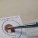 A DNA sample card is handled with tweezers in 7NEWS Spotlight Investigates: DNA Disasters