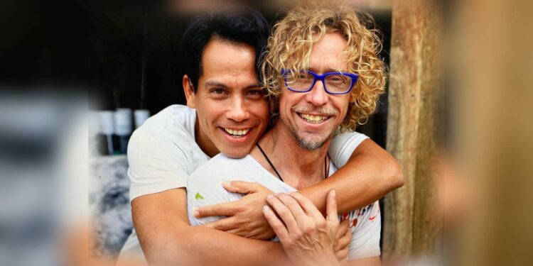 Roberto Meza Mont embraces Craig Ruddy in a publicity photograph for A Portrait of Love