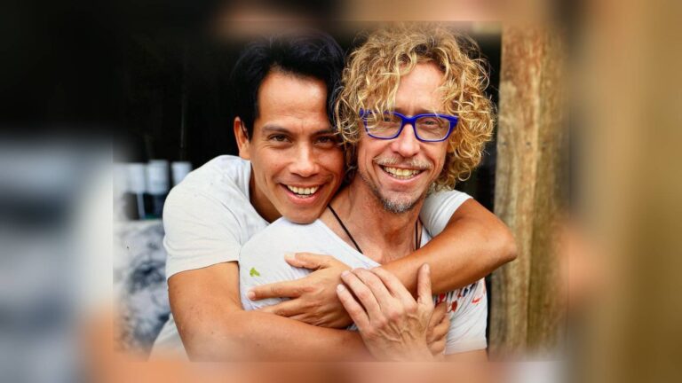 Roberto Meza Mont embraces Craig Ruddy in a publicity photograph for A Portrait of Love
