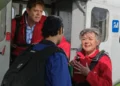Characters in skydiving gear beside a plane in Beyond Paradise on ABC