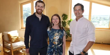 The host with homeowners in a sunlit room in Grand Designs New Zealand on ABC