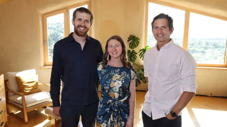 The host with homeowners in a sunlit room in Grand Designs New Zealand on ABC