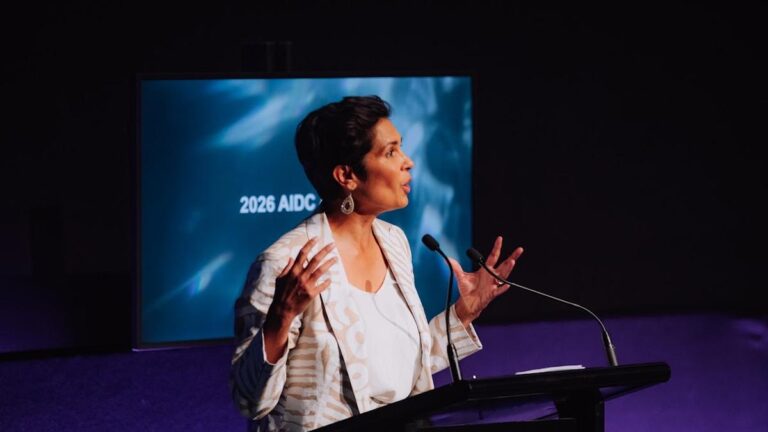 Speaker addresses the 2026 AIDC conference at a lectern