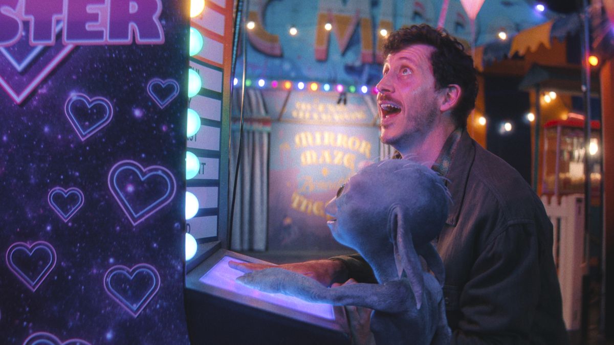 Petey and Allen together at a brightly lit fairground in the Netflix film Allen