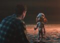 Petey and Allen face each other on a moonlit beach