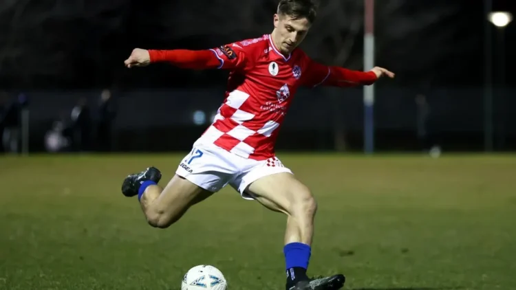 Footballer striking a ball in Australian Championship 2026 coverage