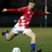Footballer striking a ball in Australian Championship 2026 coverage