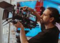 Camera operator adjusting a professional television camera