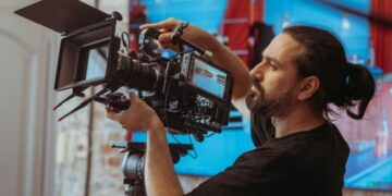 Camera operator adjusting a professional television camera