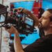 Camera operator adjusting a professional television camera