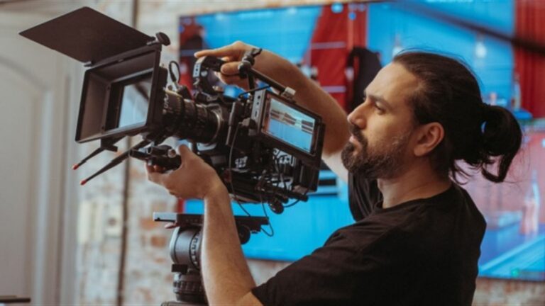 Camera operator adjusting a professional television camera