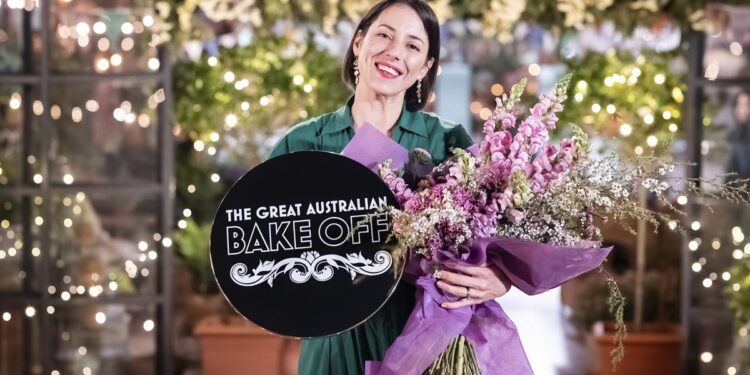 Pamela Buchanan holding her Great Australian Bake Off winner trophy and flowers