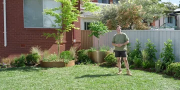 Charlie stands in the completed family garden on Better Homes and Gardens