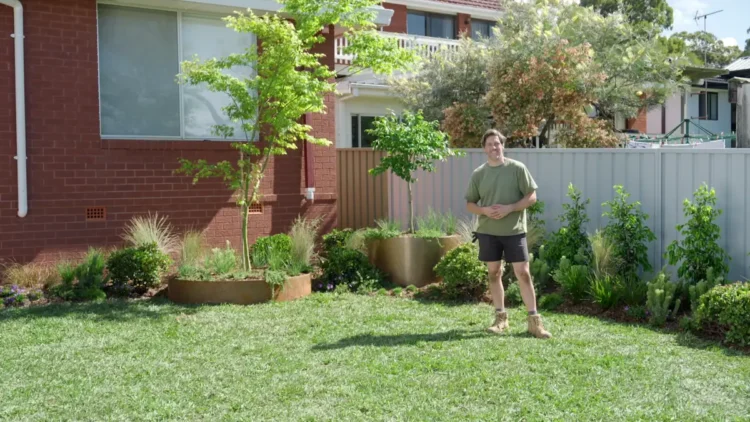 Charlie stands in the completed family garden on Better Homes and Gardens
