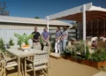 Adam and Charlie beside the curved pergola and outdoor dining area on Better Homes and Gardens