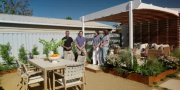 Adam and Charlie beside the curved pergola and outdoor dining area on Better Homes and Gardens