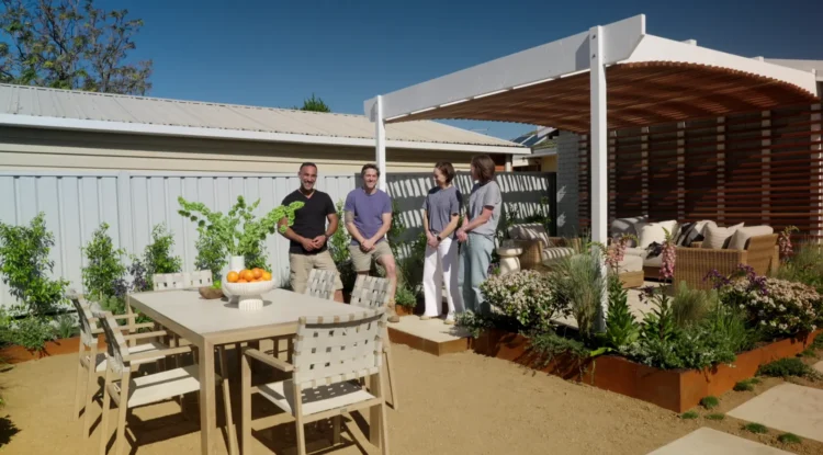 Adam and Charlie beside the curved pergola and outdoor dining area on Better Homes and Gardens