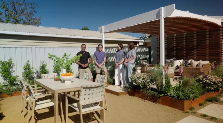 Adam and Charlie beside the curved pergola and outdoor dining area on Better Homes and Gardens