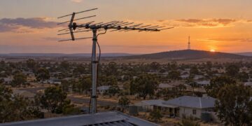Illustrative television aerial overlooking a regional Australian town at sunset
