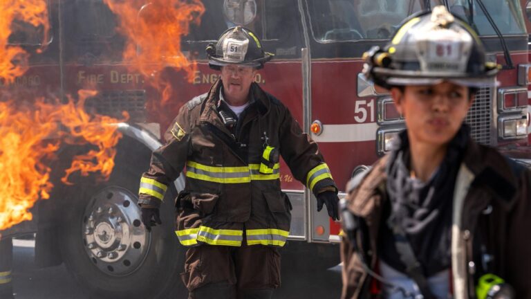 Firefighters in front of a burning fire truck in Chicago Fire season 14 on Channel 7