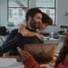 Jordan Firstman laughs as Reggie Absolom hugs him from behind in Club Kid