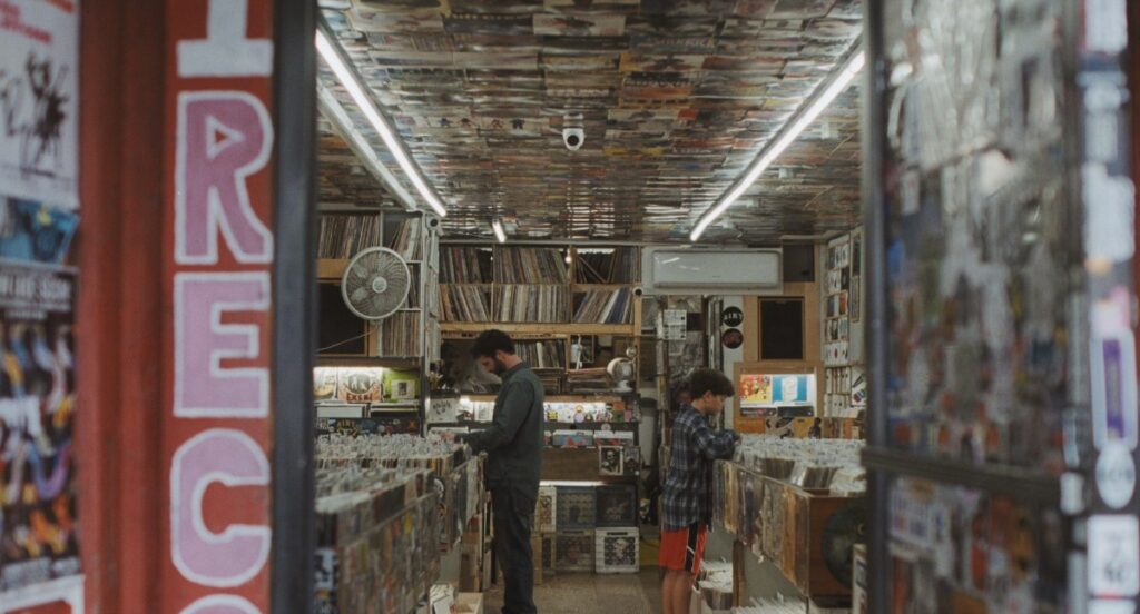 A father and son browse records in a New York record store in Club Kid