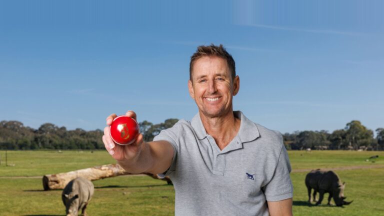 Mark Howard holding a red cricket ball in Fox Cricket publicity imagery