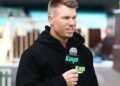 David Warner speaking into a Kayo Sports microphone