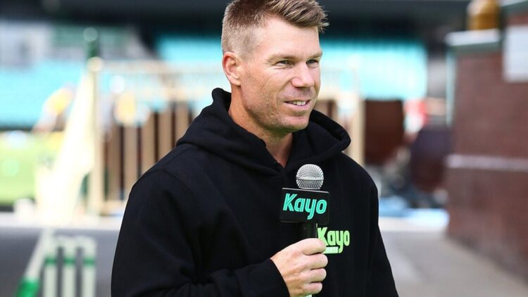 David Warner speaking into a Kayo Sports microphone