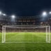 Illustrative football stadium and goal under floodlights