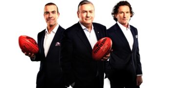 Eddie McGuire with fellow Footy Classified panellists holding Sherrin footballs