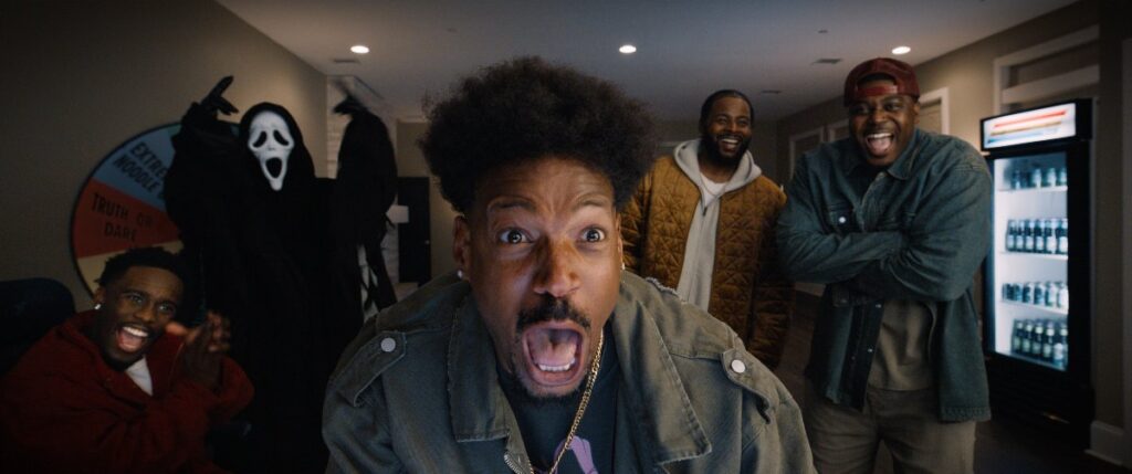 A terrified group with Ghostface behind them in Scary Movie (2026)
