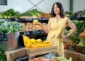 Melissa Leong stands in a fresh produce market for Healthy, Wealthy and Wise on Channel 10.