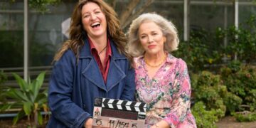 Kate Box and Sarah Peirse holding a Help Me! clapperboard in Sydney